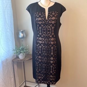 Black cocktail dress with cap sleeve and lace front panel.
